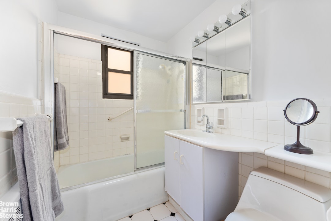 11 Riverside Drive, Unit 10PE Manhattan, NY 10023 - Photo 8 of 15 a bathroom with a sink toilet and shower