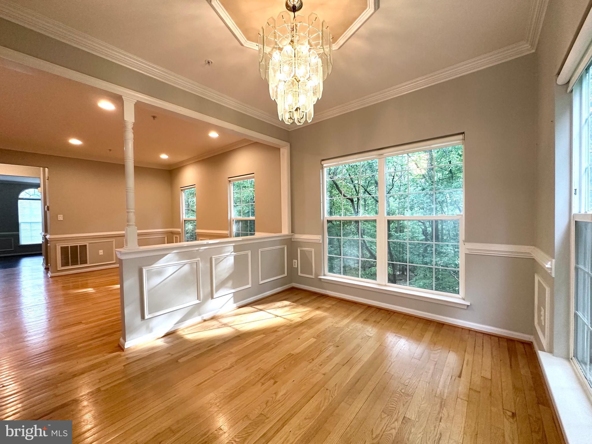 18100 Truffle Lane Boyds, MD 20841 - Photo 16 of 39 a large white kitchen with large windows and a chandelier