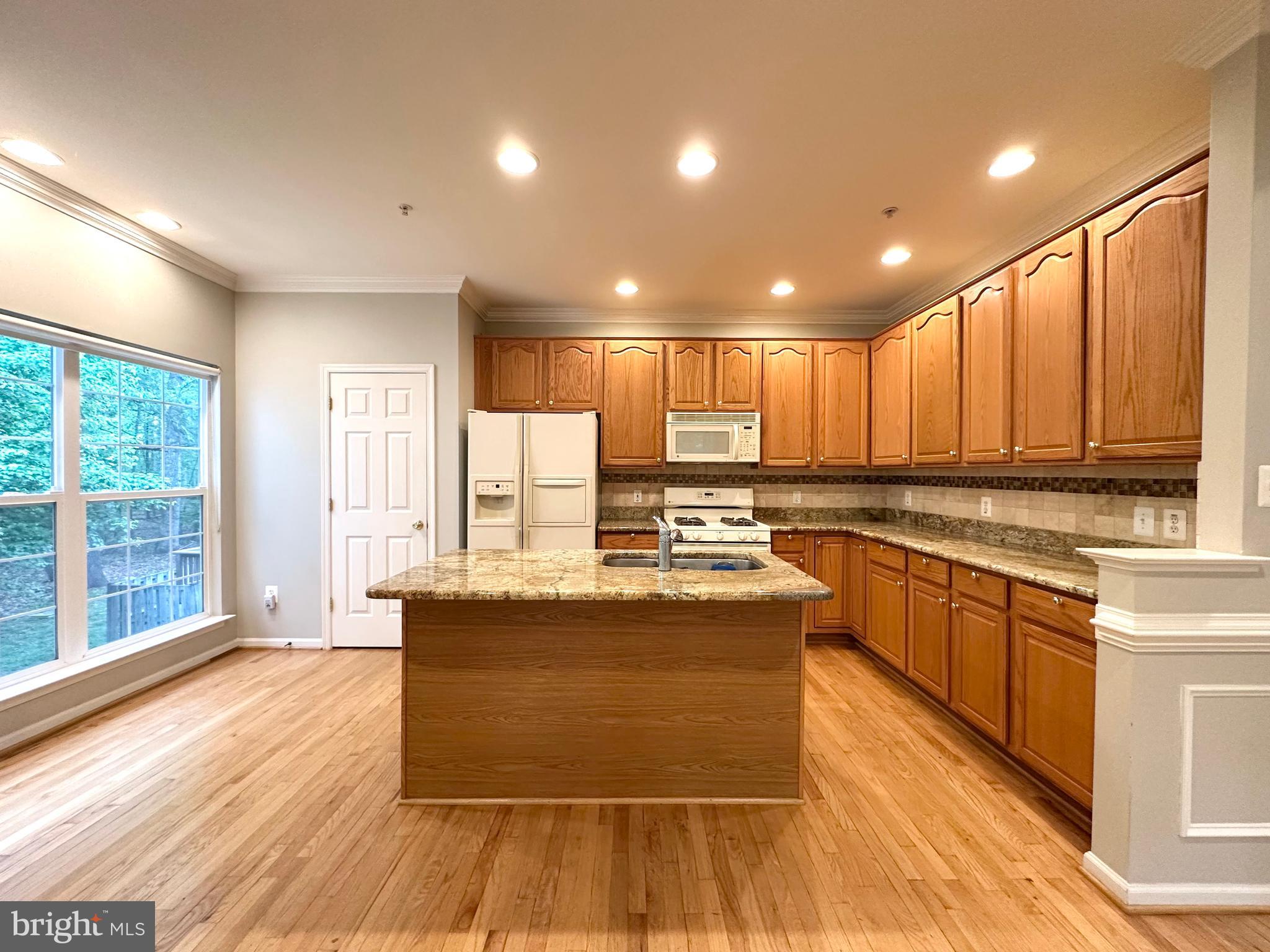 18100 Truffle Lane Boyds, MD 20841 - Photo 19 of 39 a large kitchen with kitchen island a large counter top space a sink stainless steel appliances and cabinets