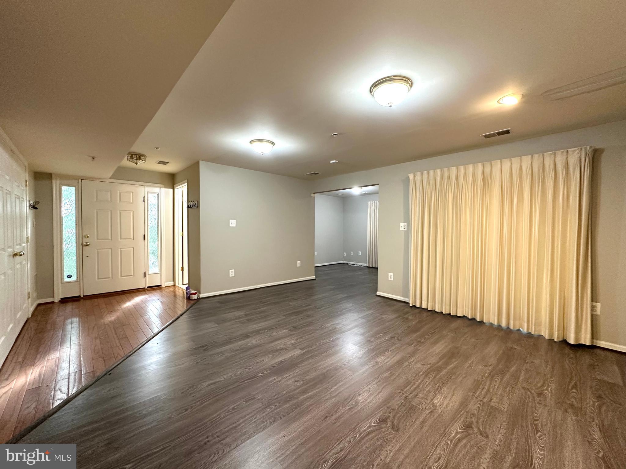 18100 Truffle Lane Boyds, MD 20841 - Photo 3 of 39 an empty room with wooden floor and windows