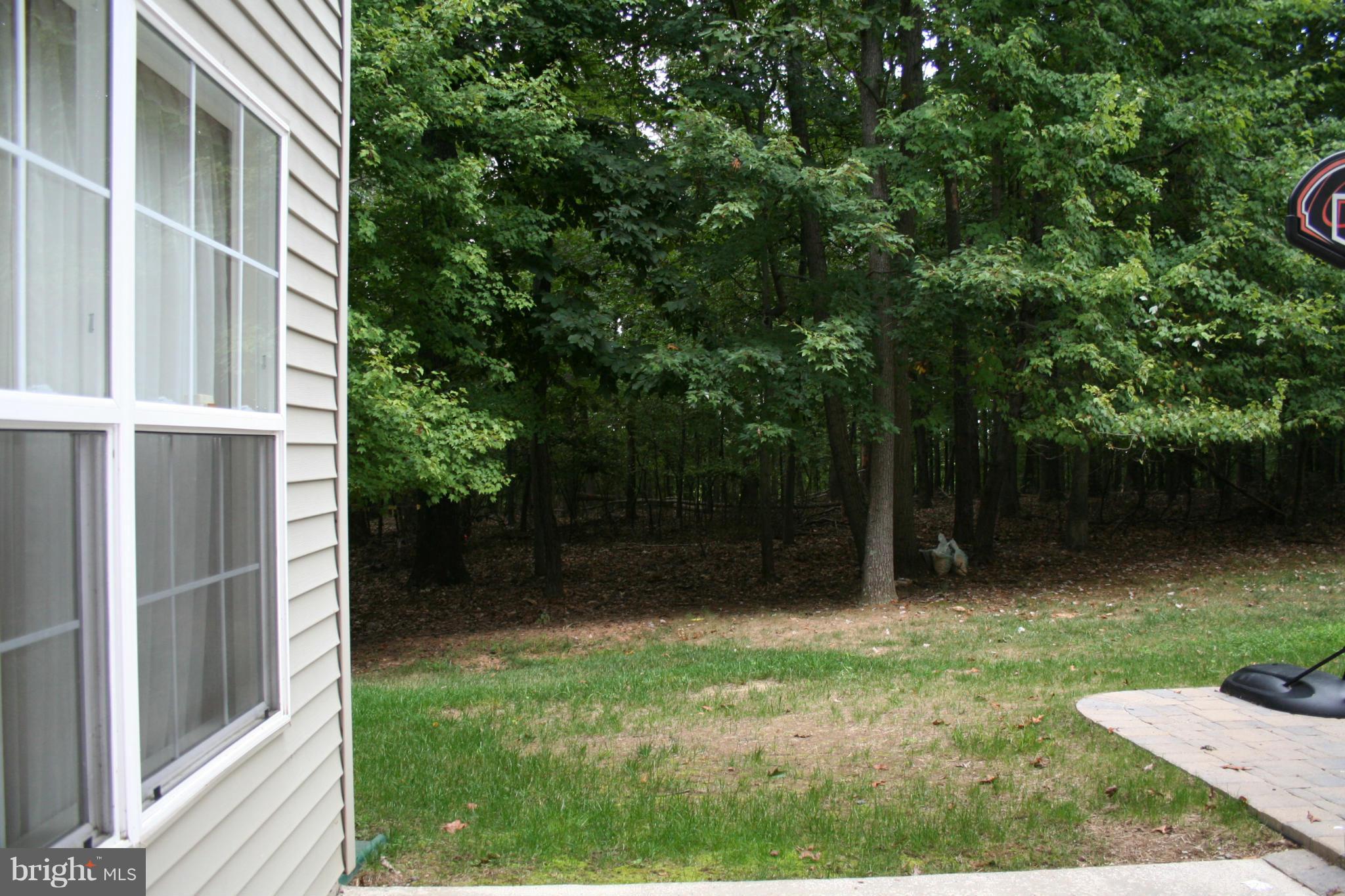 18100 Truffle Lane Boyds, MD 20841 - Photo 39 of 39 a view of a backyard with large trees and wooden fence