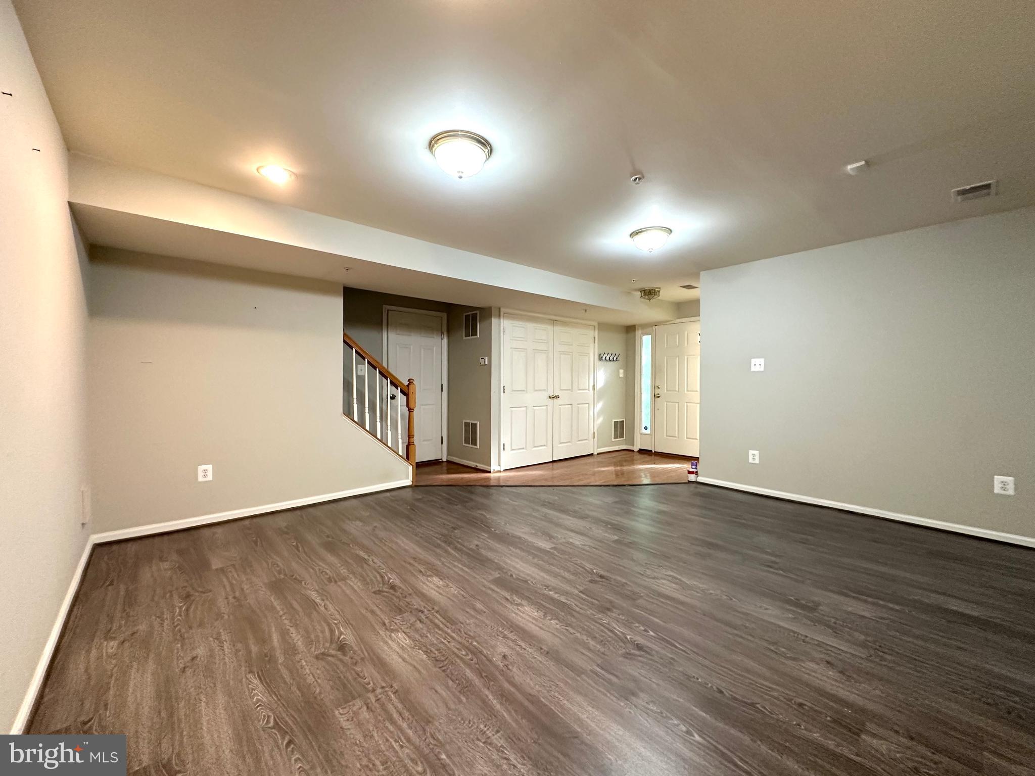 18100 Truffle Lane Boyds, MD 20841 - Photo 5 of 39 an empty room with wooden floor and windows