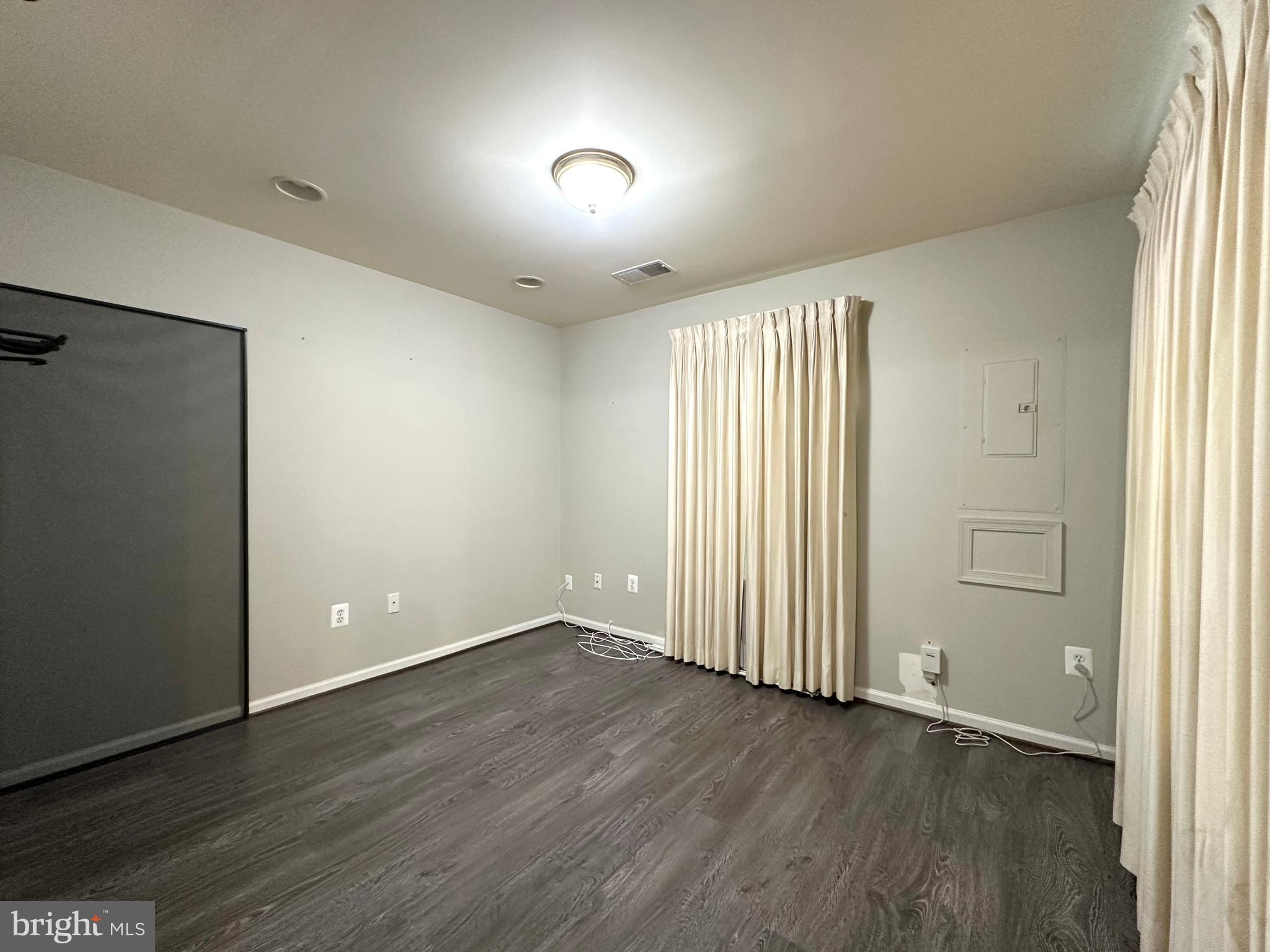 18100 Truffle Lane Boyds, MD 20841 - Photo 7 of 39 an empty room with wooden floor and windows