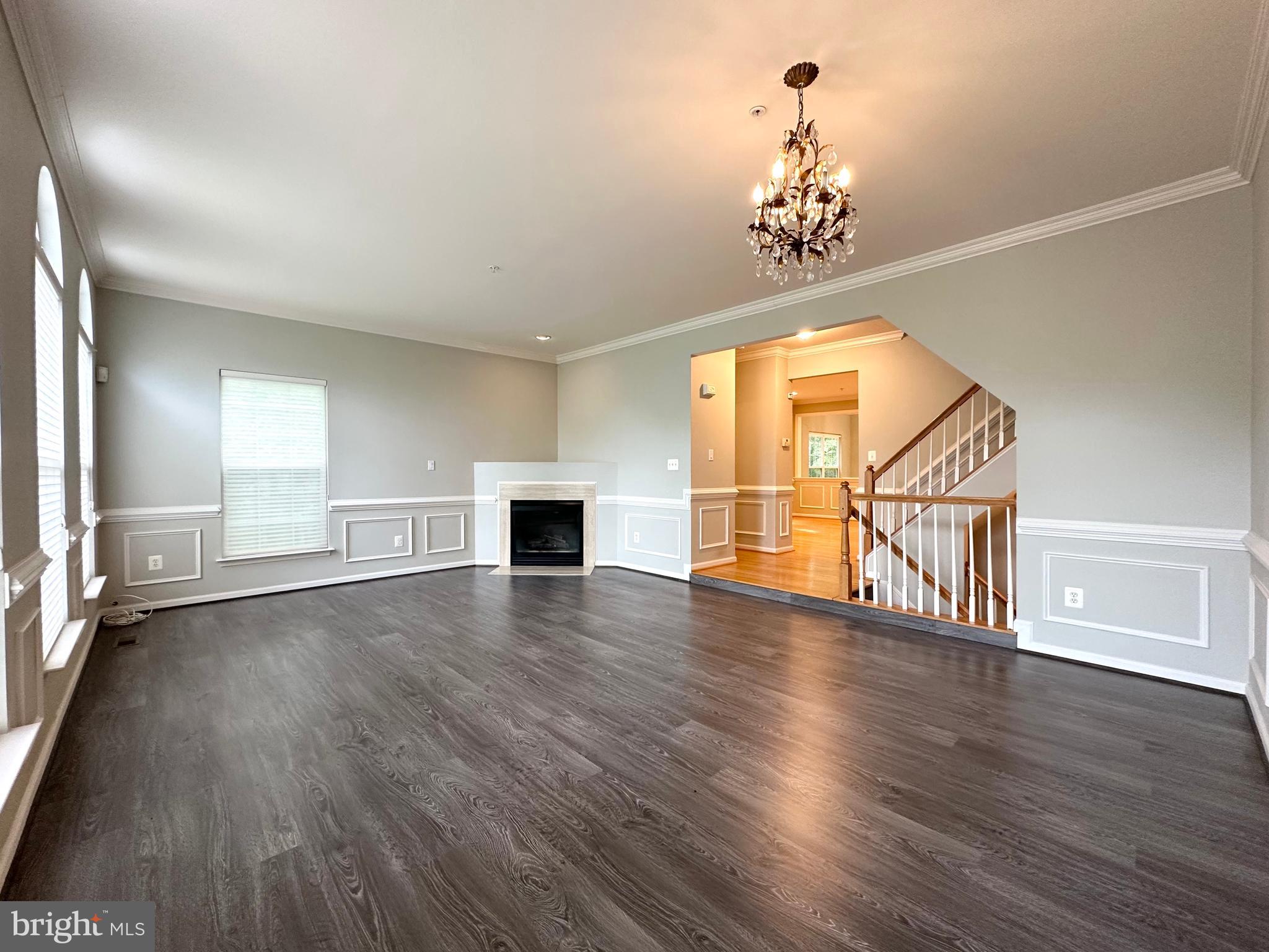18100 Truffle Lane Boyds, MD 20841 - Photo 9 of 39 an empty room with wooden floor staircase and windows
