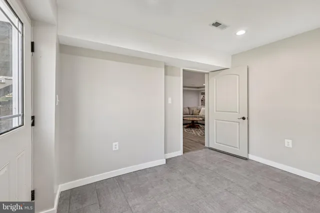 a bathroom with a granite countertop sink a toilet and a mirror