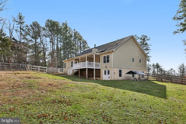 a view of a house with a yard and a deck