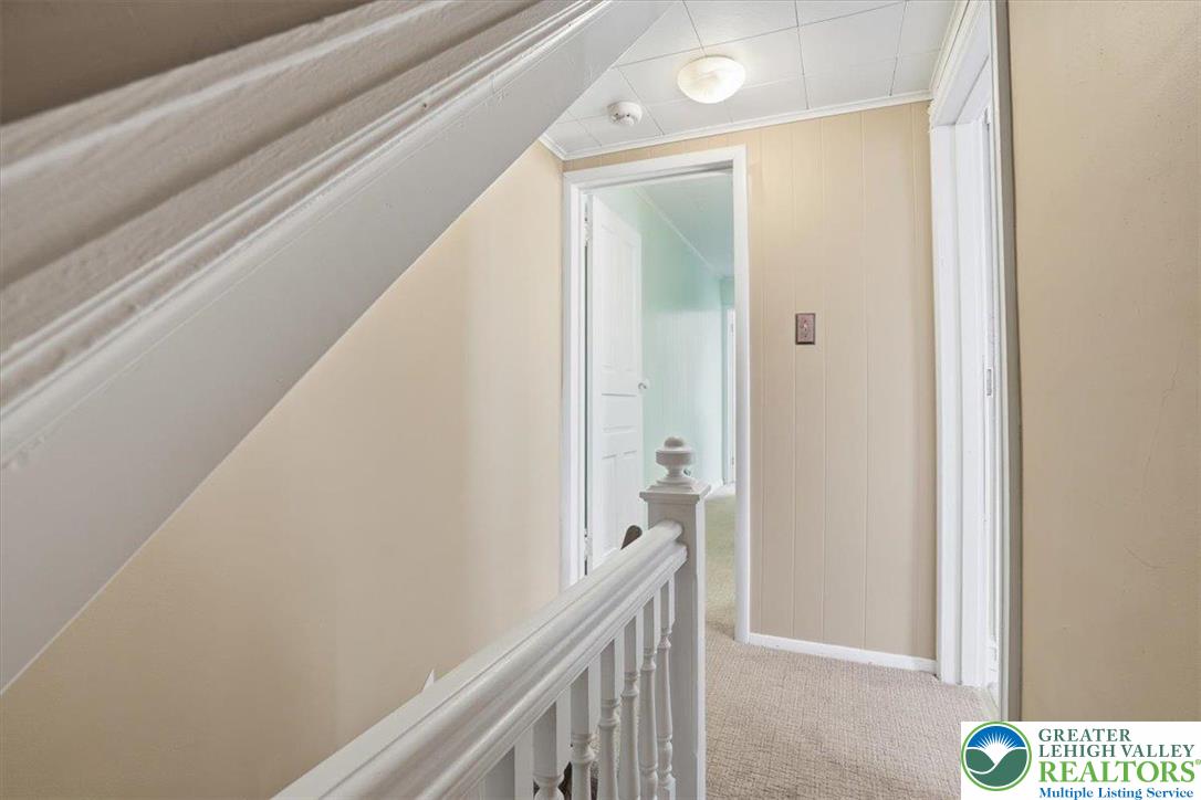 525 Ridge Street Emmaus, PA 18049 - Photo 34 of 68 This interior hallway features carpeted flooring and classic trim details.