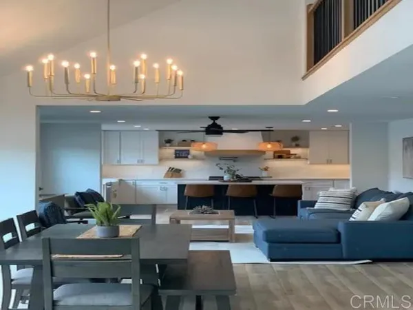 a living room with furniture and a chandelier