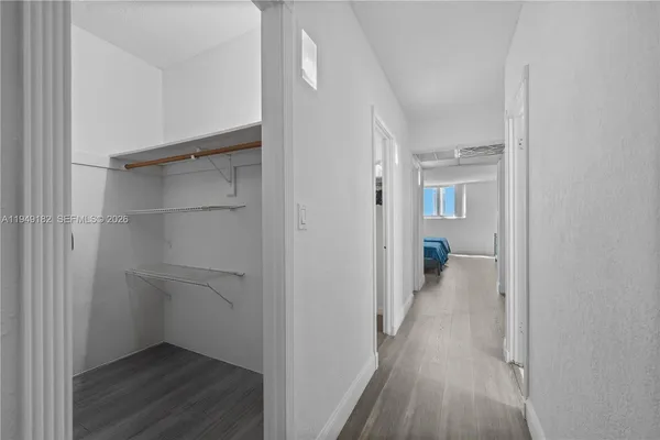a view of a hallway with wooden floor