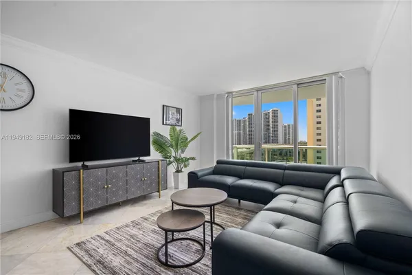 a living room with furniture and a flat screen tv