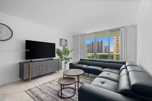 a living room with furniture and a flat screen tv