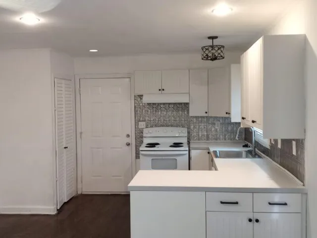 a kitchen with a sink a stove and refrigerator
