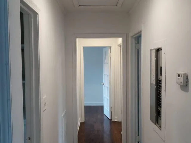 a view of a hallway with wooden floor