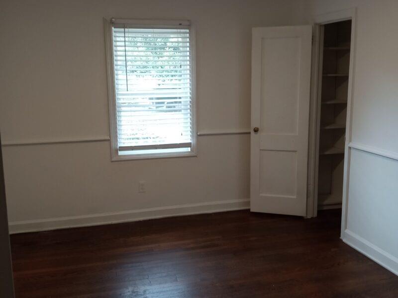 3545 Orchard Street Clarkston, GA 30021 - Photo 5 of 13 an empty room with wooden floor and windows