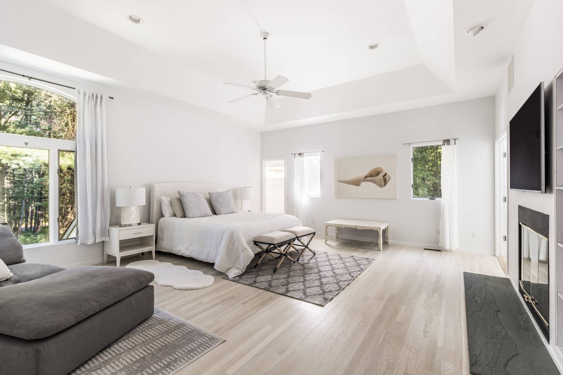 52 Bull Path East Hampton, NY 11937 - Photo 11 of 24 a living room with furniture a flat screen tv and a large window