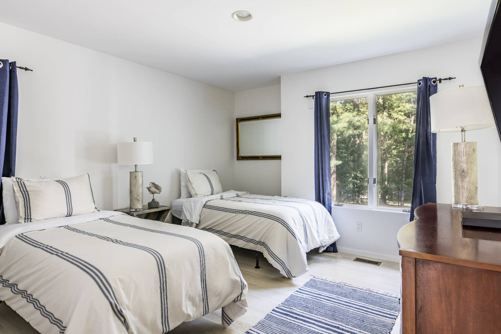 52 Bull Path East Hampton, NY 11937 - Photo 17 of 24 a bedroom with two beds and a large window