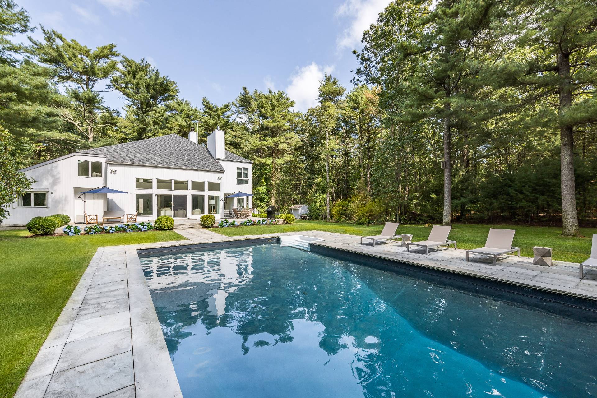 52 Bull Path East Hampton, NY 11937 - Photo 2 of 24 a view of a house with swimming pool and sitting area