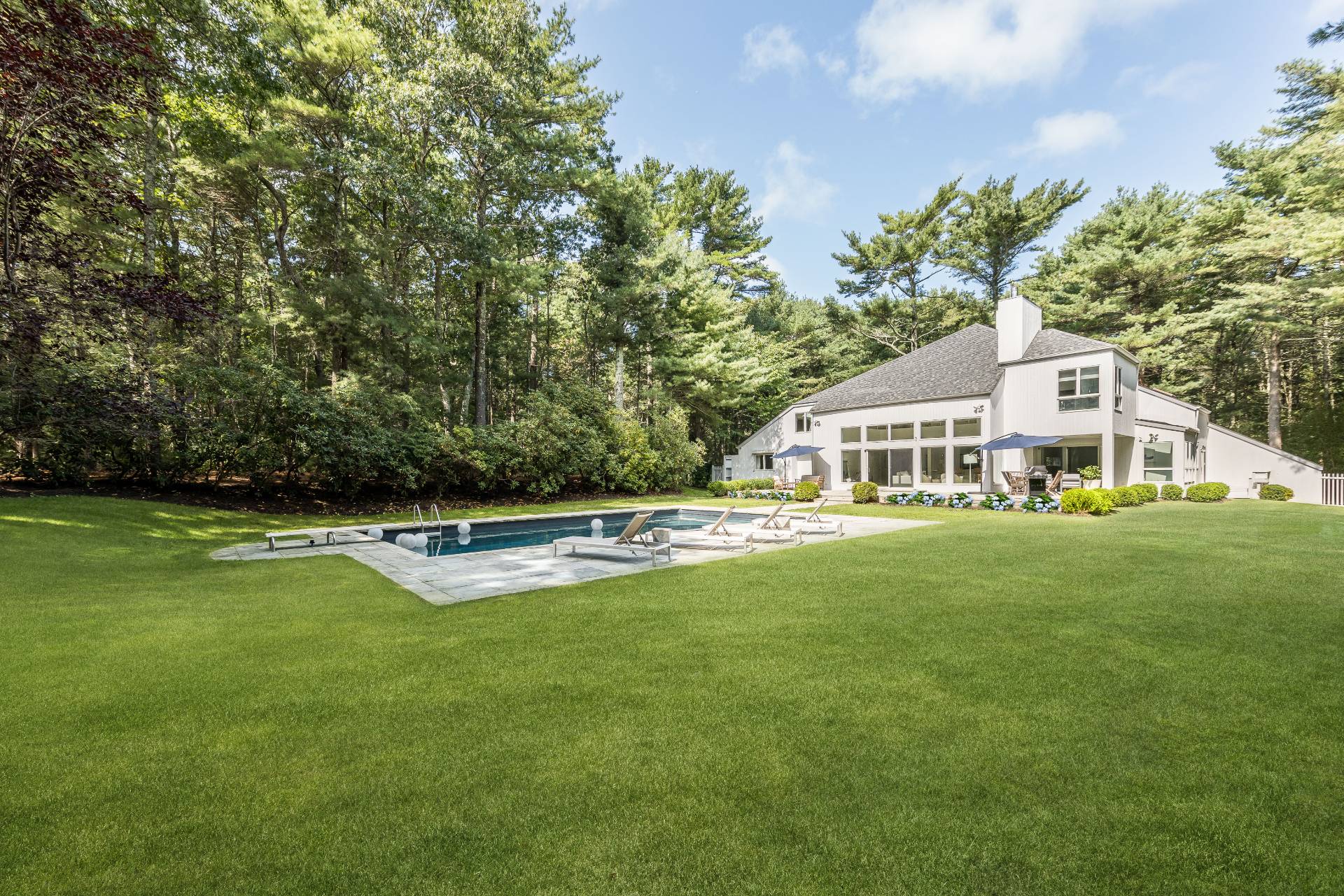52 Bull Path East Hampton, NY 11937 - Photo 22 of 24 a aerial view of a house with swimming pool and porch with green space