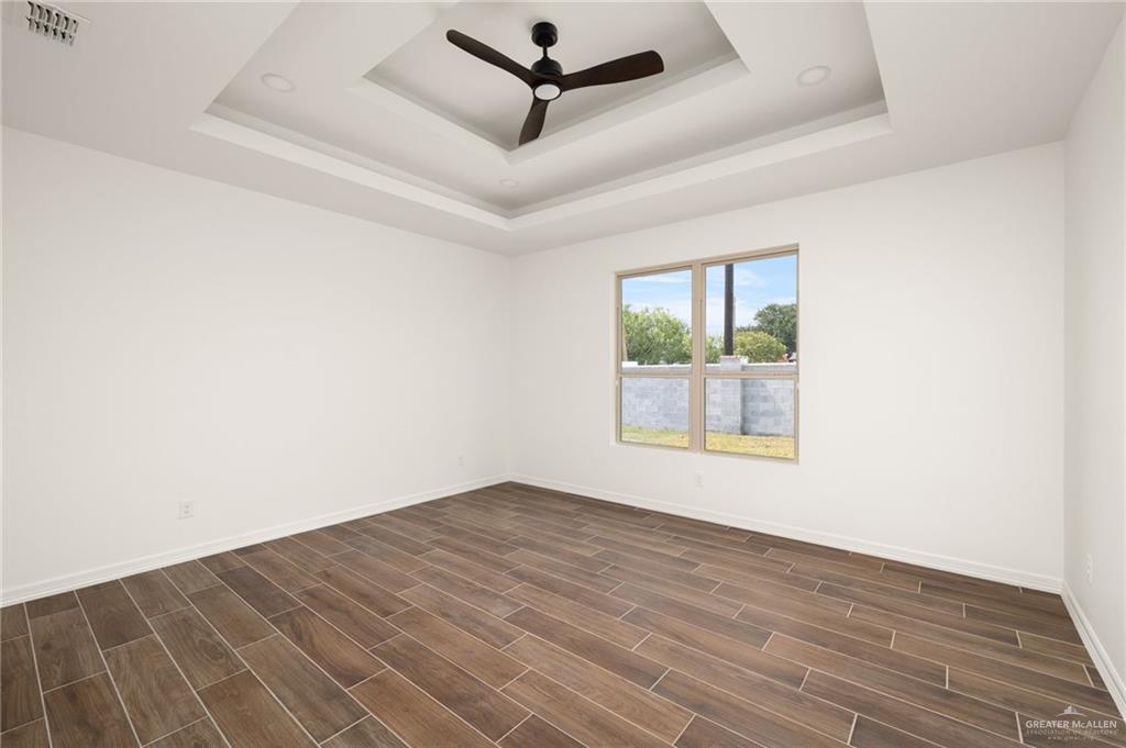 4805 Baylor Avenue McAllen, TX 78504 - Photo 5 of 14 an empty room with wooden floor and windows
