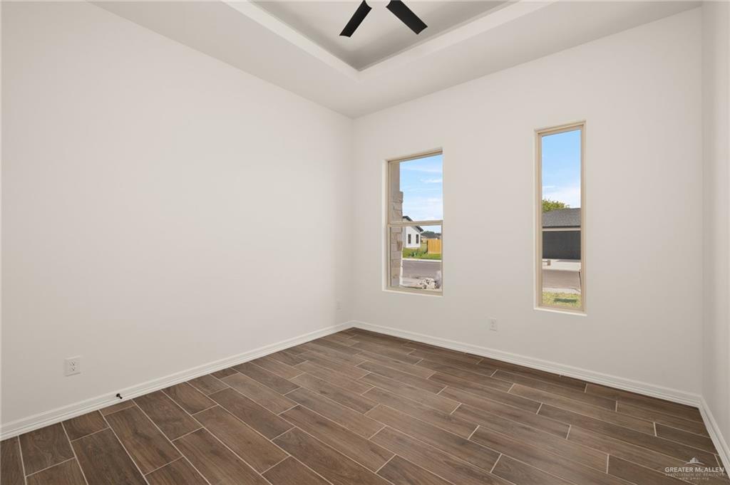 4805 Baylor Avenue McAllen, TX 78504 - Photo 7 of 14 an empty room with a window and ceiling fan