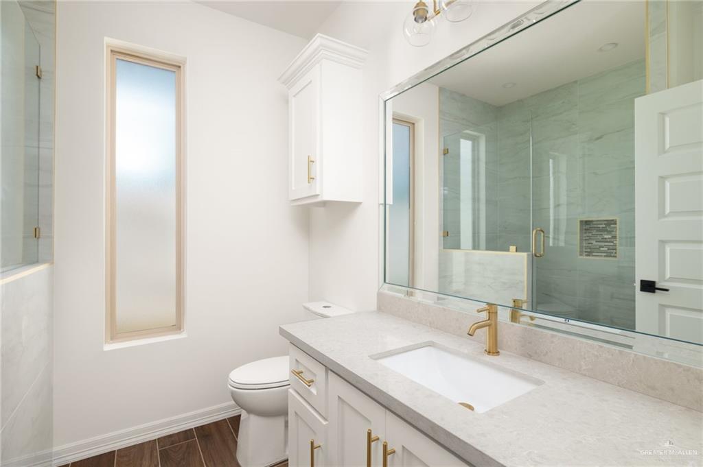 4805 Baylor Avenue McAllen, TX 78504 - Photo 9 of 14 a bathroom with a sink toilet vanity and shower