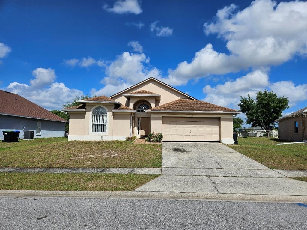 a front view of a house with a yard and garage
