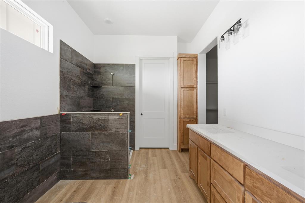 496 Willow Moon Ranch Road Crawford, TX 76638 - Photo 13 of 16 a bathroom with a sink and shower