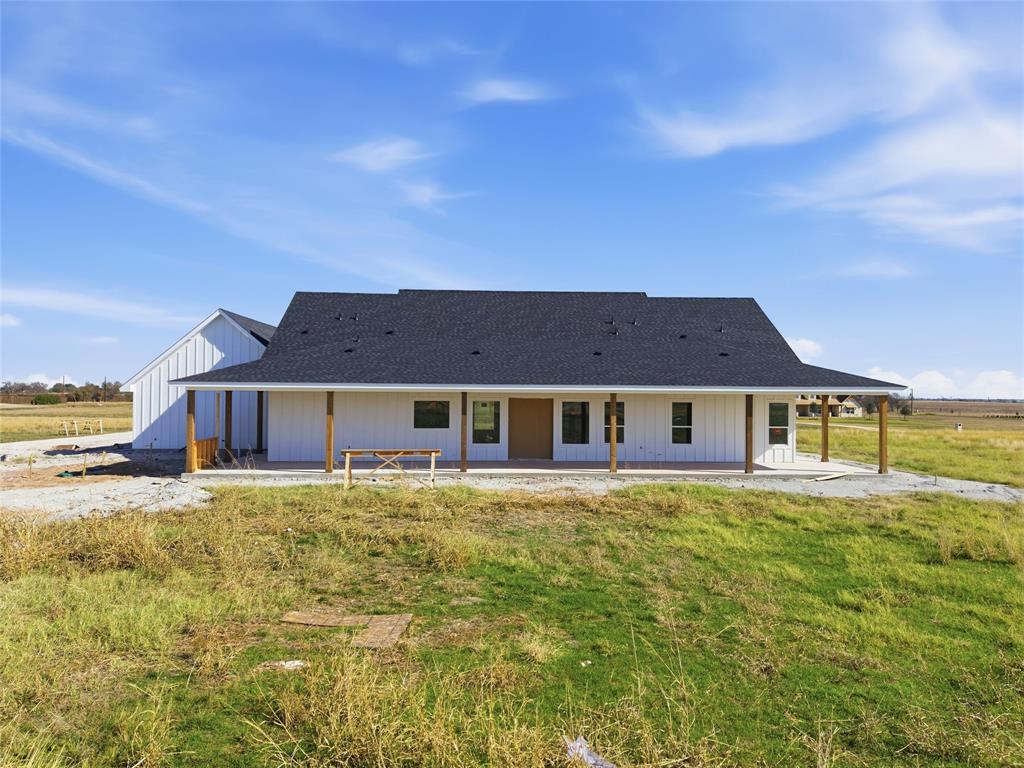 496 Willow Moon Ranch Road Crawford, TX 76638 - Photo 2 of 16 a big house with a big yard and large trees