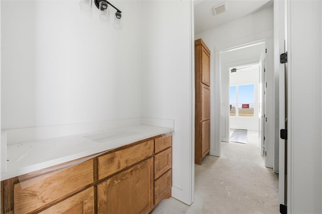 496 Willow Moon Ranch Road Crawford, TX 76638 - Photo 4 of 16 a view of a hallway with closet and a window