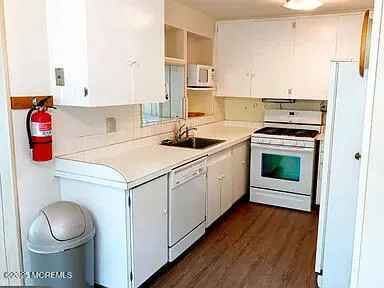 a kitchen with a stove top oven sink and cabinets