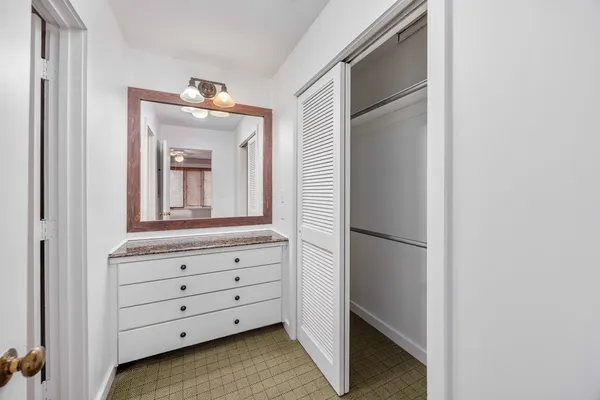 a room with a dresser and mirror
