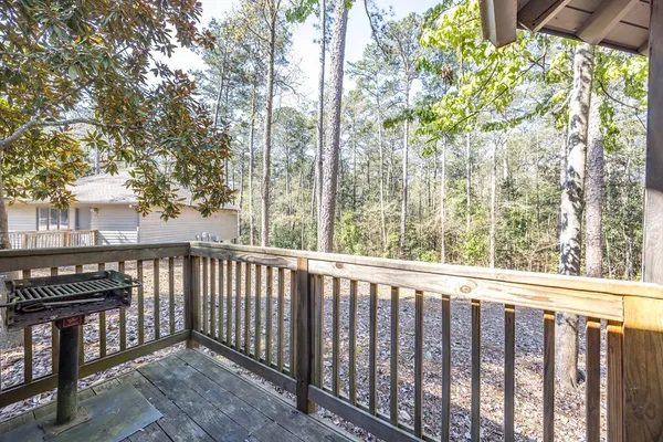 a view of a balcony with wooden fence and floor