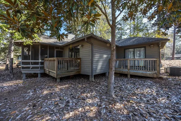 a backyard of a house with barbeque oven wooden floor and fence