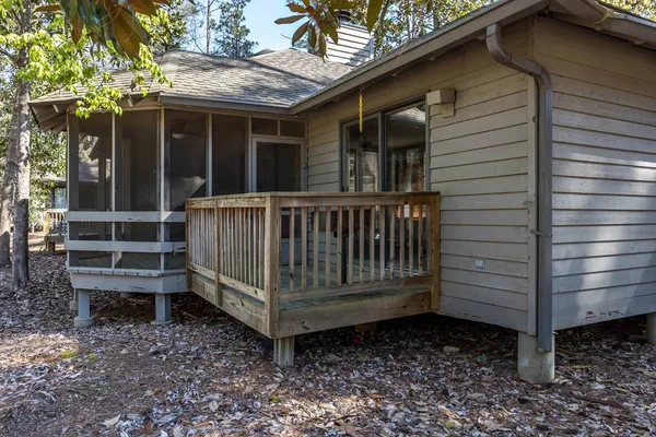 a view of a wooden house with a yard