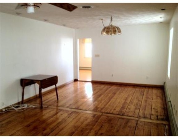 175 Trenton Street, Unit 3 Boston, MA 02128 - Photo 3 of 5 a view of a room with wooden floor and a window