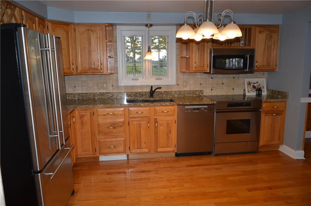 747 Charles Street Rochester, PA 15074 - Photo 2 of 23 New Pella window sets off this kitchen with granite counters and modern appliances