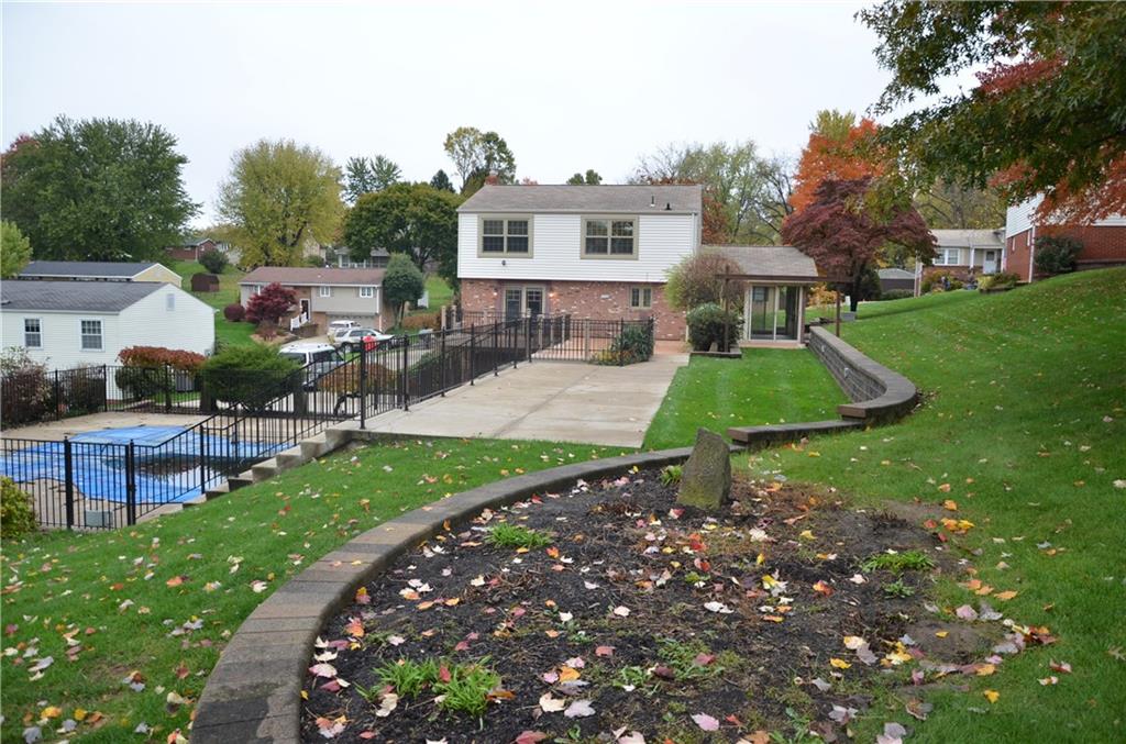 747 Charles Street Rochester, PA 15074 - Photo 21 of 23 Serpentine retaining walls are maintained and have built in lighting with timers.