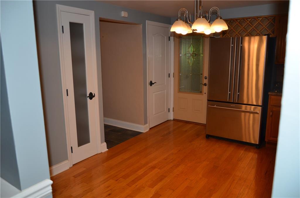 747 Charles Street Rochester, PA 15074 - Photo 4 of 23 Kitchen (as seen from dining rm) showing pantry, doors to basement and 3 season rm