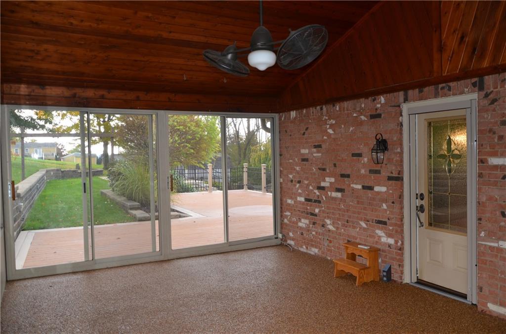 747 Charles Street Rochester, PA 15074 - Photo 9 of 23 3 Season Room with pine-plank ceiling, leads onto the Trex-type deck and pool, large enough for family or entertaining guests!