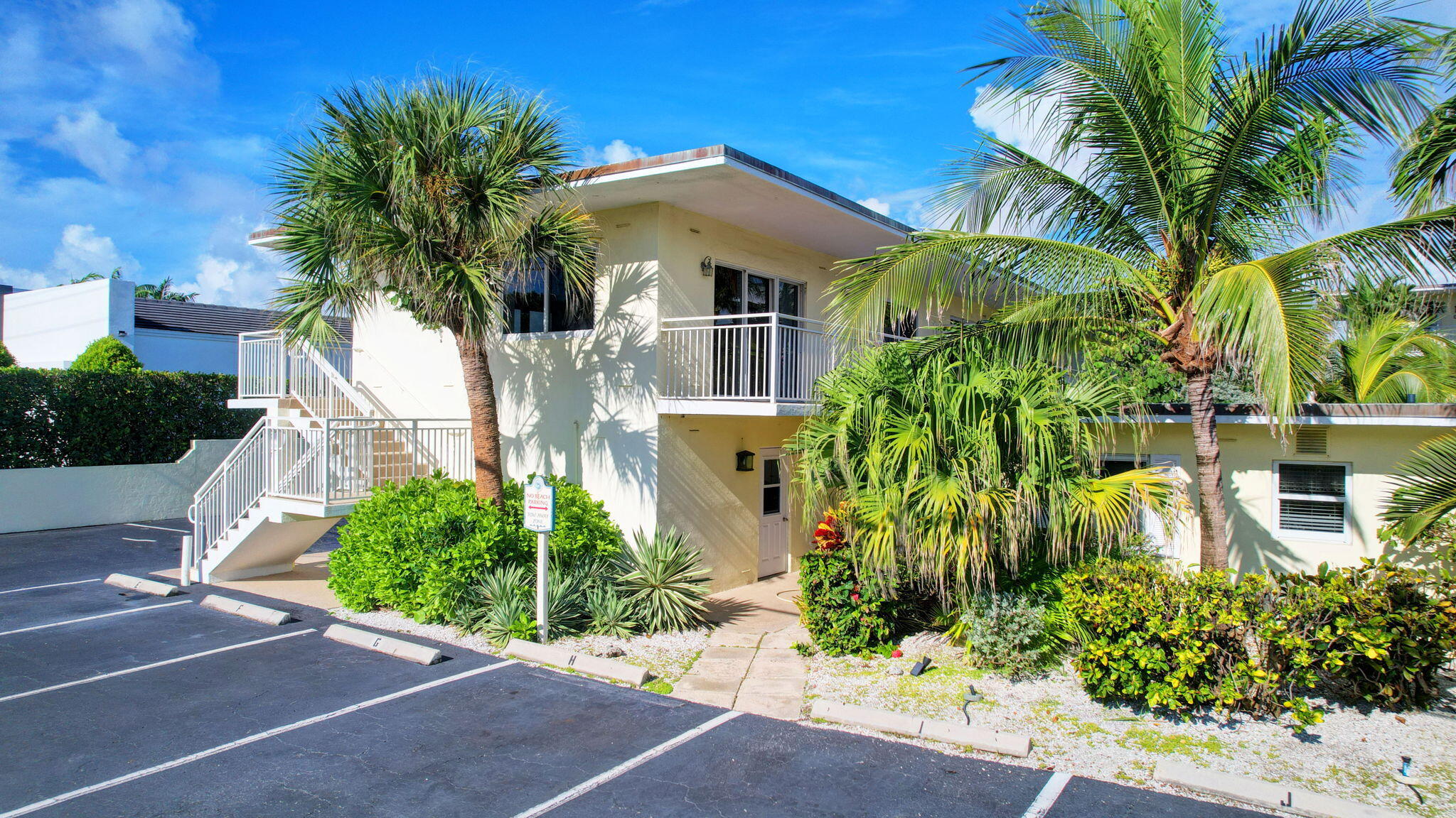 6520 North Ocean Boulevard, Unit 30 Ocean Ridge, FL 33435 - Photo 12 of 29 a front view of a house with a garden