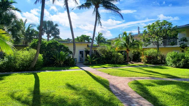 a view of a backyard with swimming pool