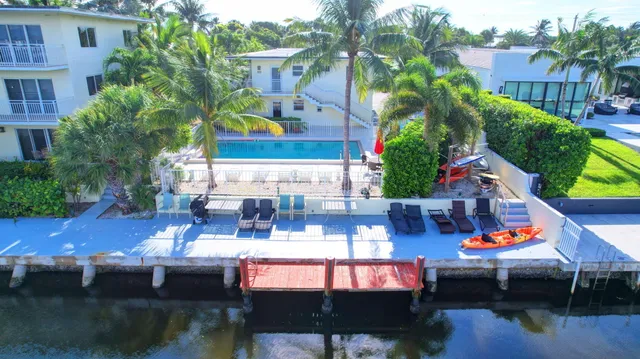 a view of house with swimming pool outdoor seating