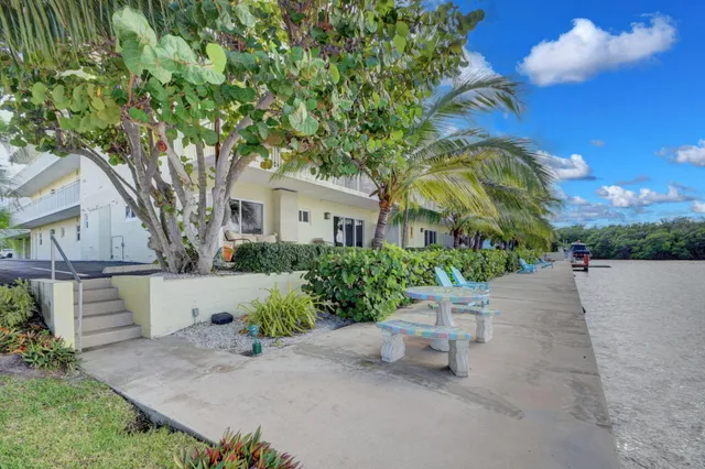 a view of a chair and table in the backyard