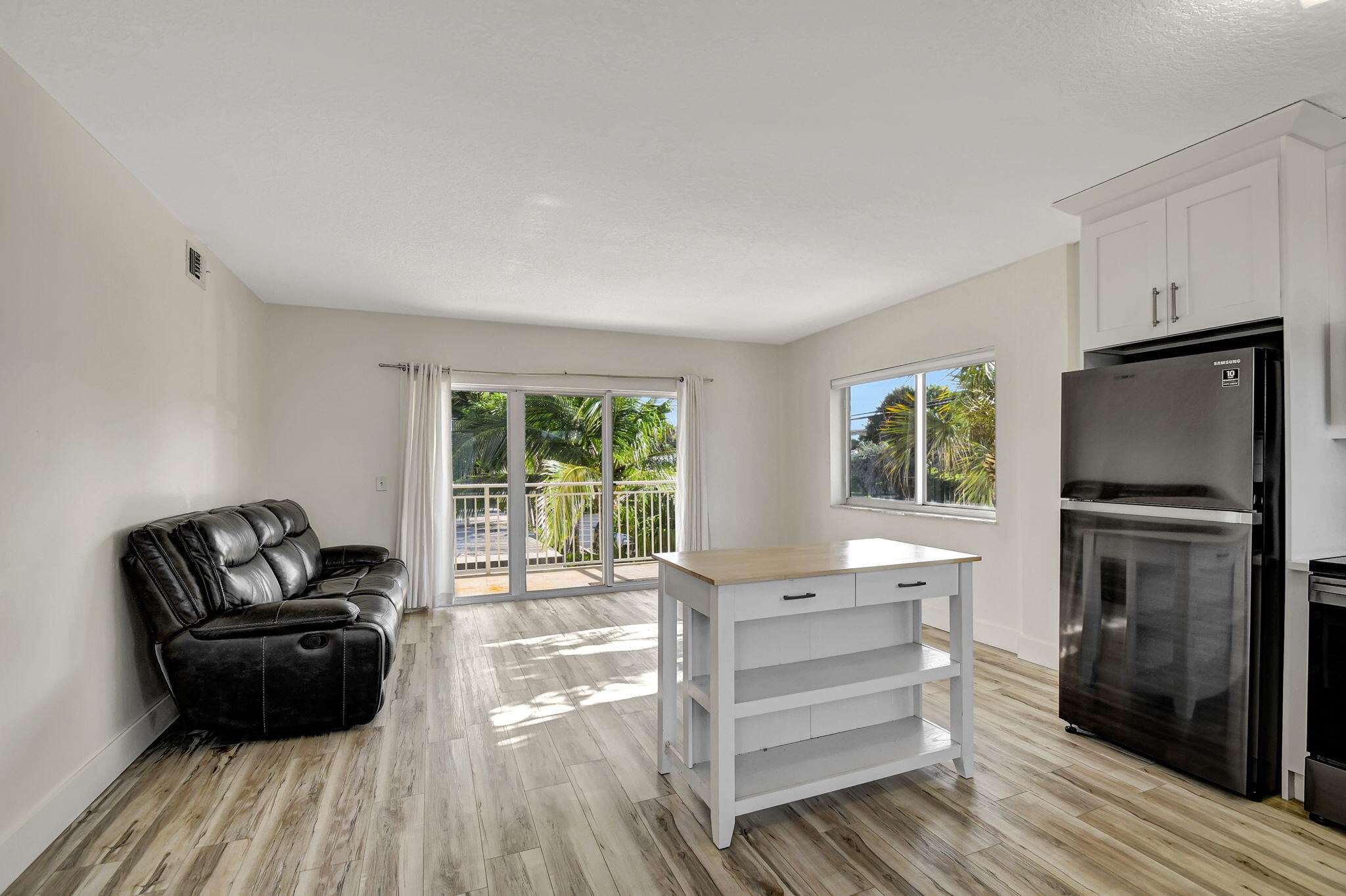 6520 North Ocean Boulevard, Unit 30 Ocean Ridge, FL 33435 - Photo 3 of 29 a living room with furniture and a flat screen tv