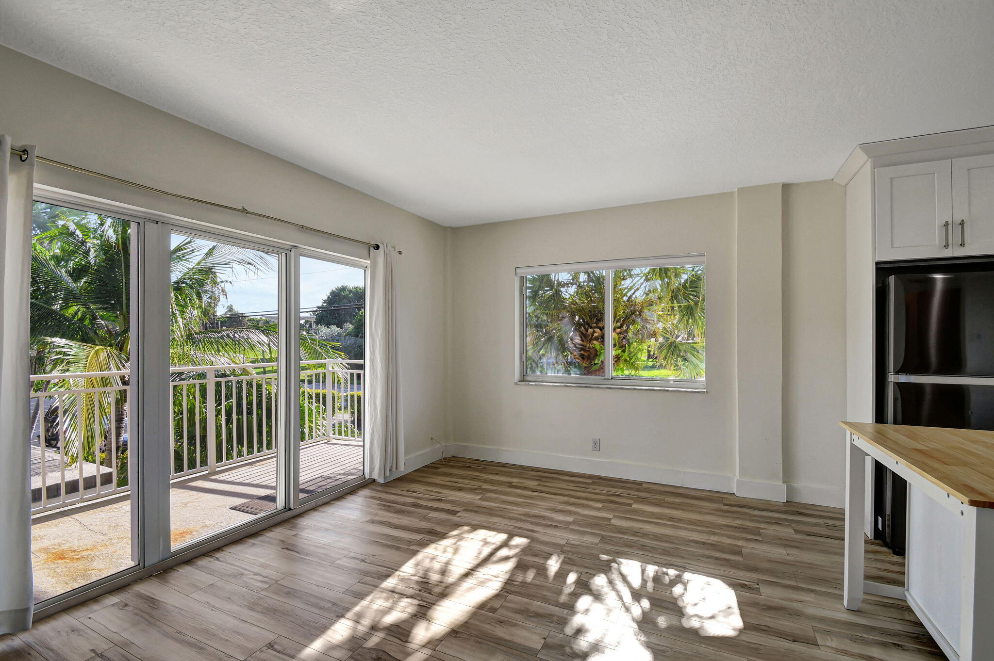 6520 North Ocean Boulevard, Unit 30 Ocean Ridge, FL 33435 - Photo 8 of 29 a view of empty room with wooden floor and fan