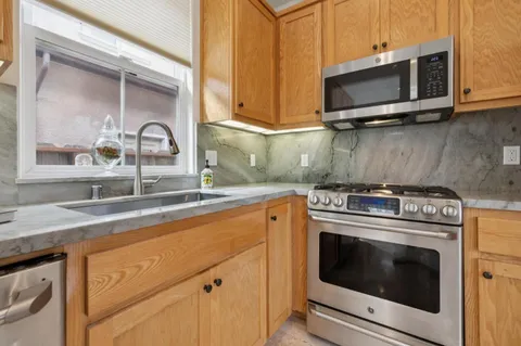 a kitchen with a stove microwave and sink