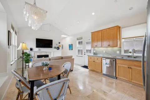 a kitchen with a table chairs microwave and cabinets