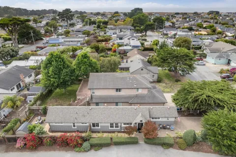 an aerial view of a house with a yard basket ball court and outdoor seating