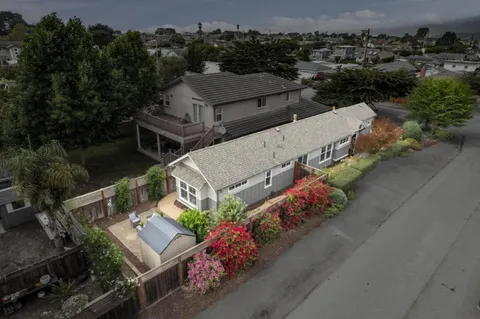 an aerial view of multiple houses with yard