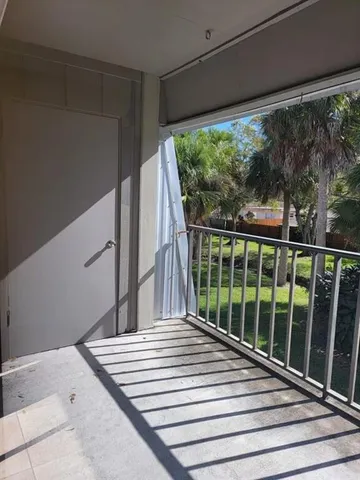 a view of a balcony with floor to ceiling windows